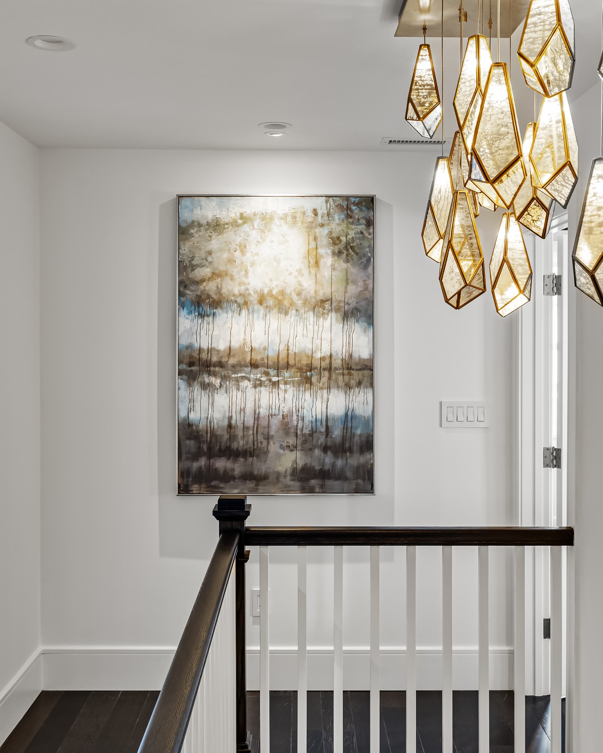 Stair hall with a statement light fixture