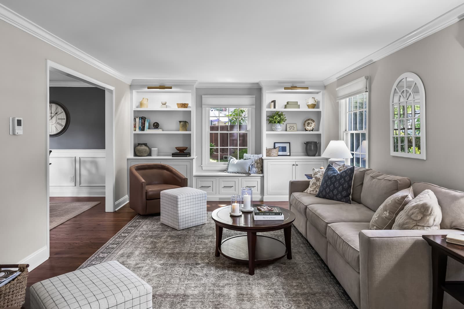 Living room with built-in shelving and an arched window in Cherry Hill, NJ