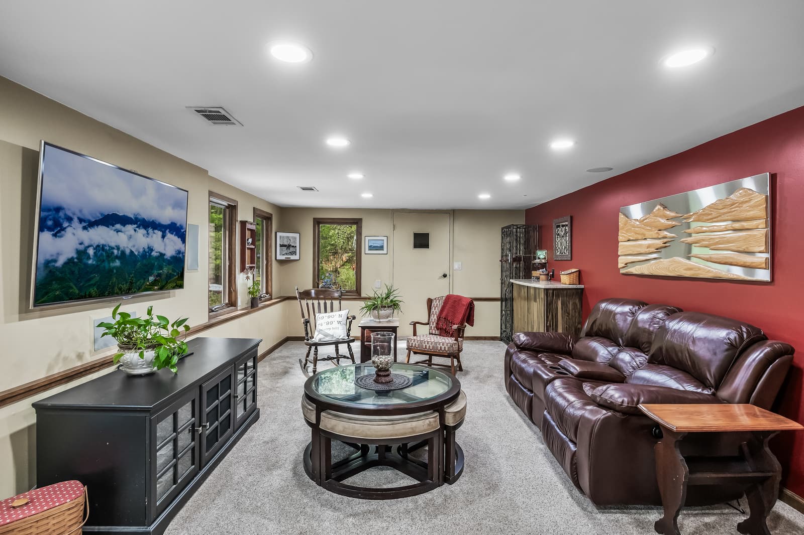 Living room with a red accent wall and leather seating in Cherry Hill, NJ