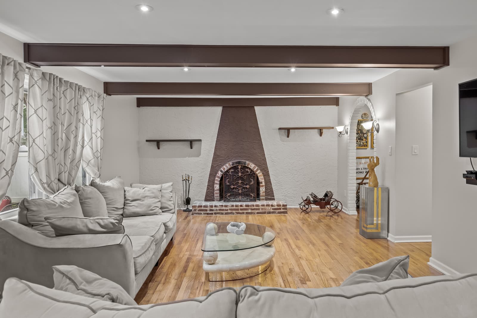 Living room with a brick fireplace and sectional in Cherry Hill, NJ