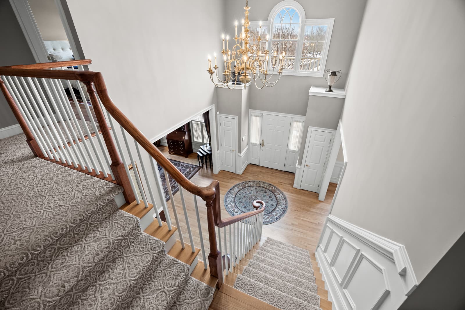 Two-story foyer with a staircase and chandelier in Cherry Hill, NJ