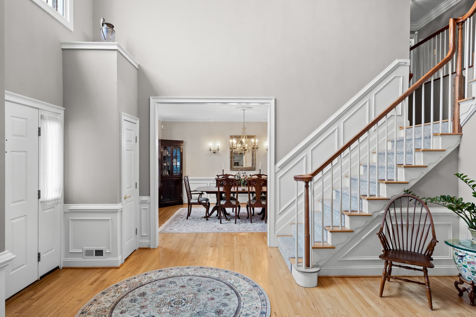 Entry foyer with a staircase overlooking the dining room in Cherry Hill, NJ