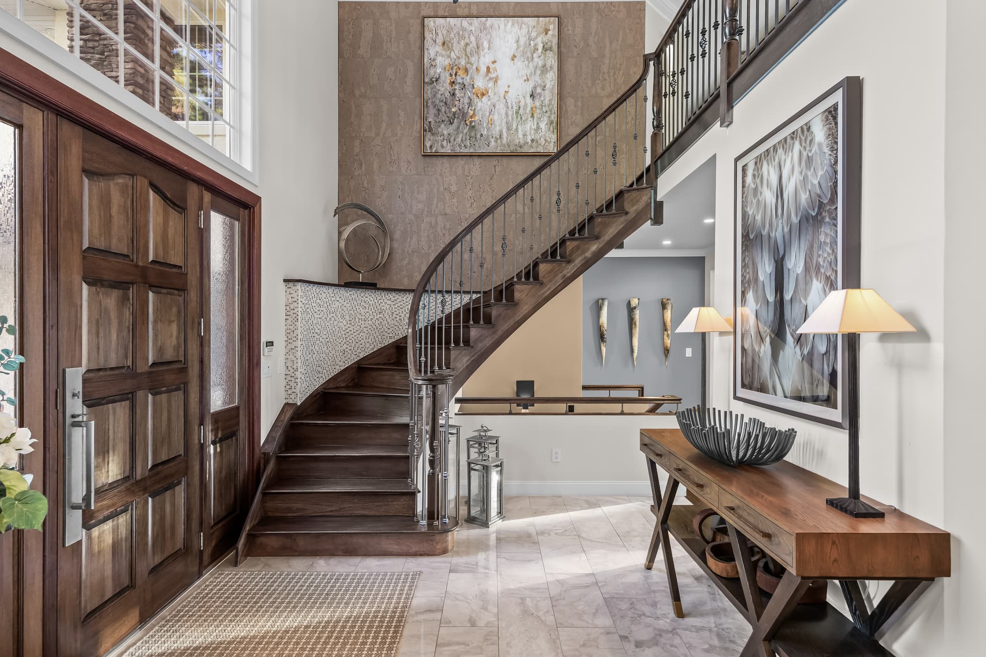 Two-story foyer with a curved wood staircase in a Marlton, NJ home