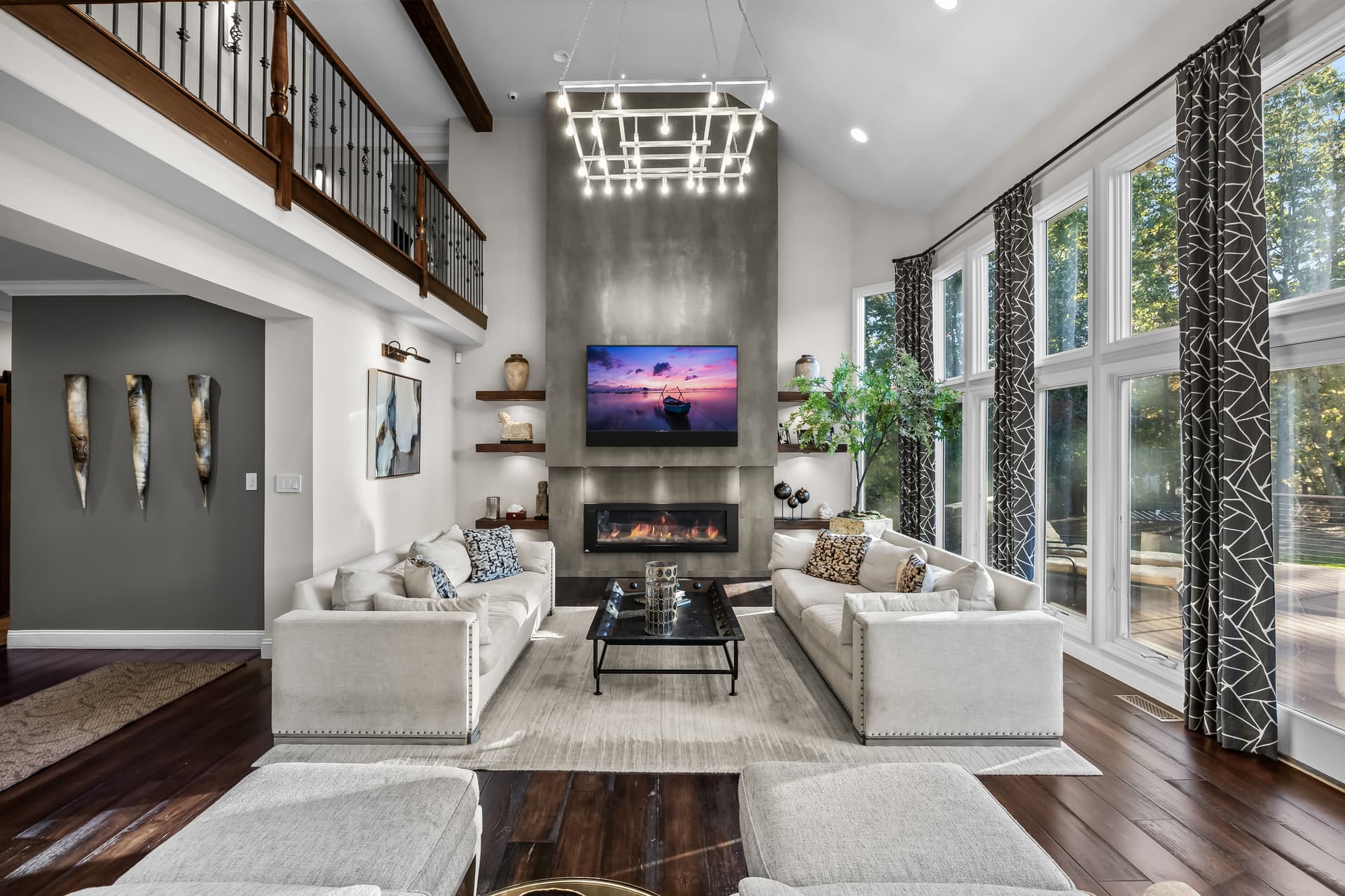 Two-story living room with a fireplace and balcony overlook in a Marlton, NJ home