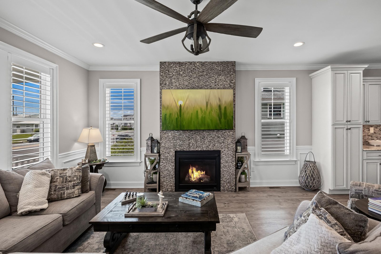 Family room with a stone fireplace and large windows in Medford, NJ