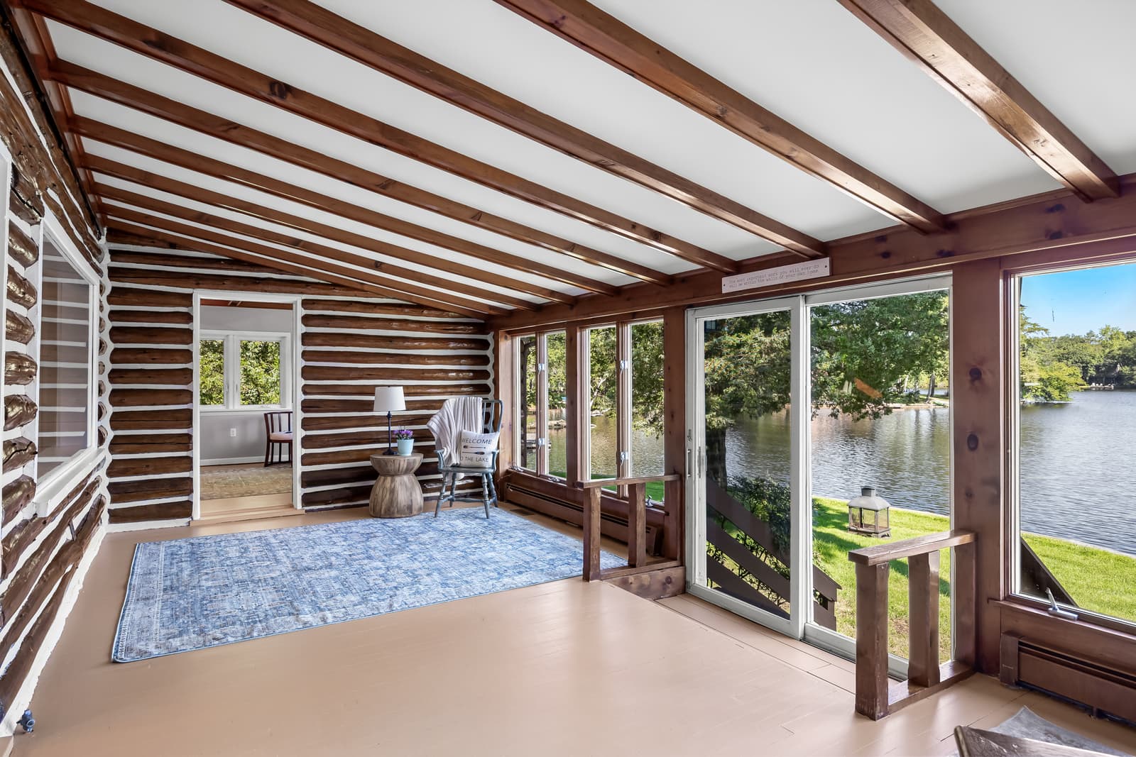Lakefront sunroom with walls of glass overlooking the water in Medford, NJ