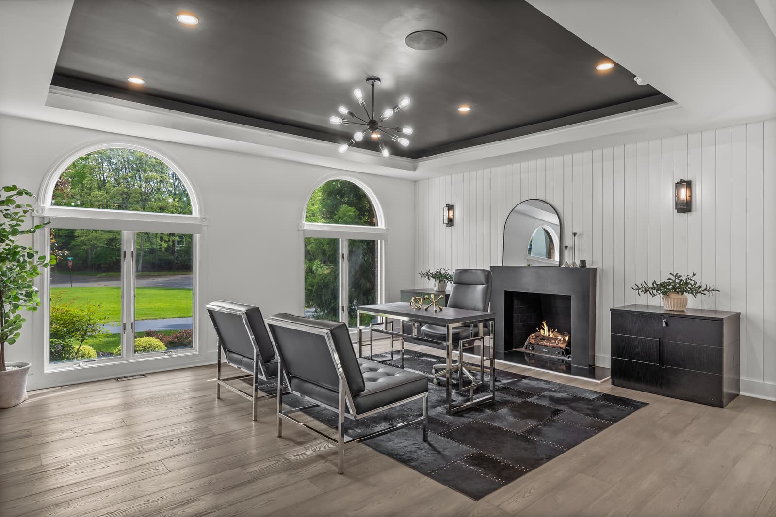 Living room with a fireplace framed by arched windows in Medford, NJ