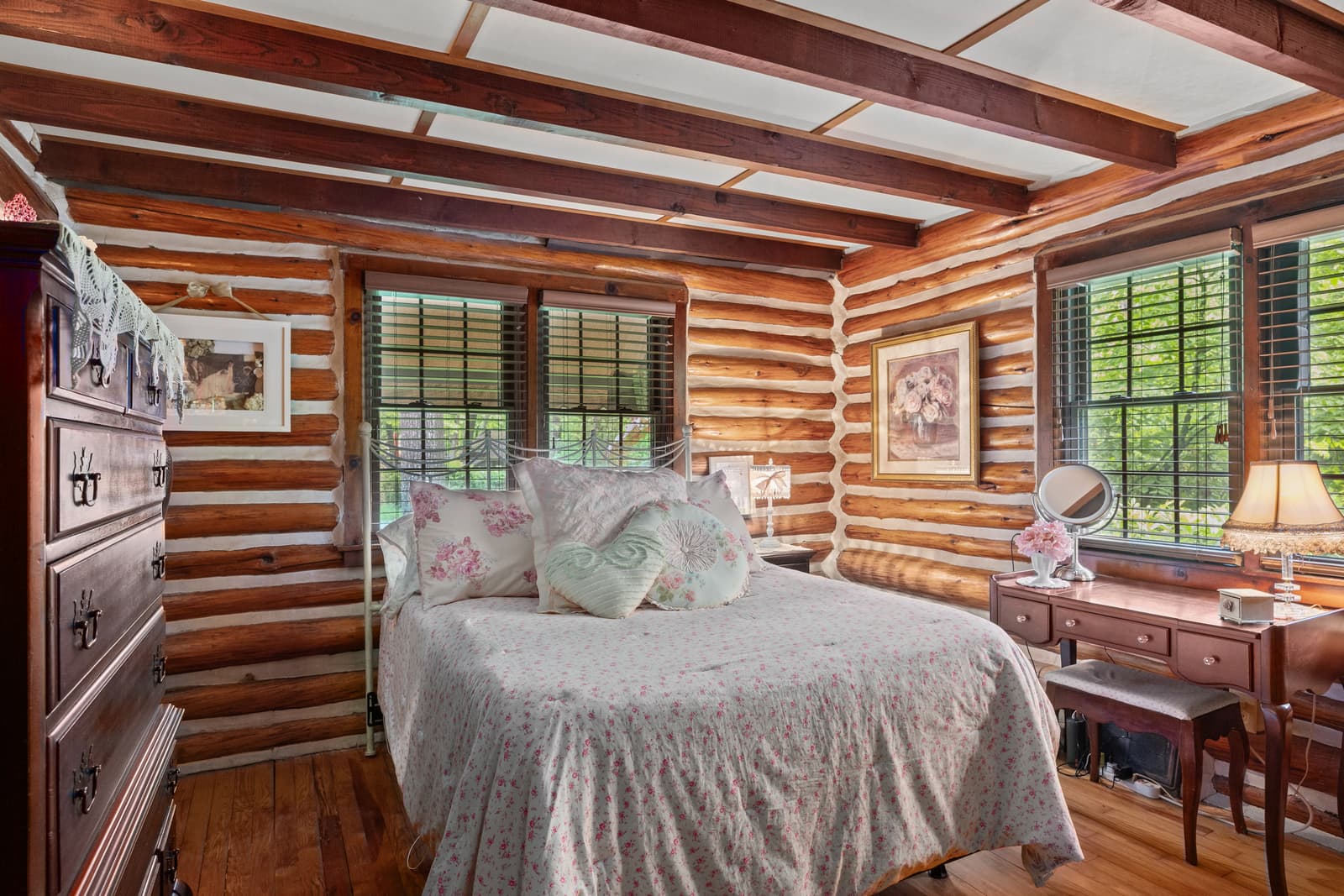 Log cabin bedroom with wood plank walls and forest views in Medford, NJ