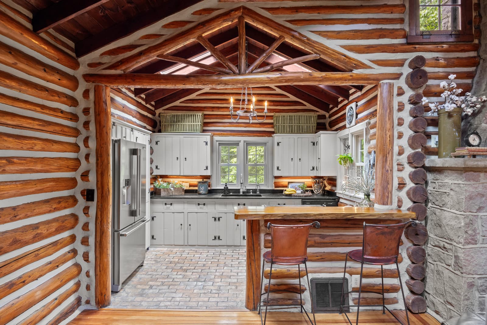 Log cabin kitchen with a wood-beam ceiling and stainless appliances in Medford, NJ