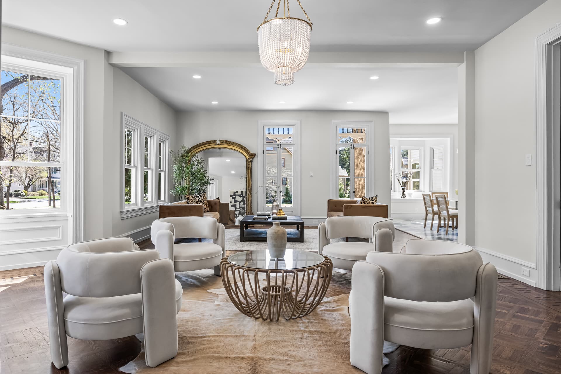 Sitting room with modern white armchairs and a glass table in a Moorestown home