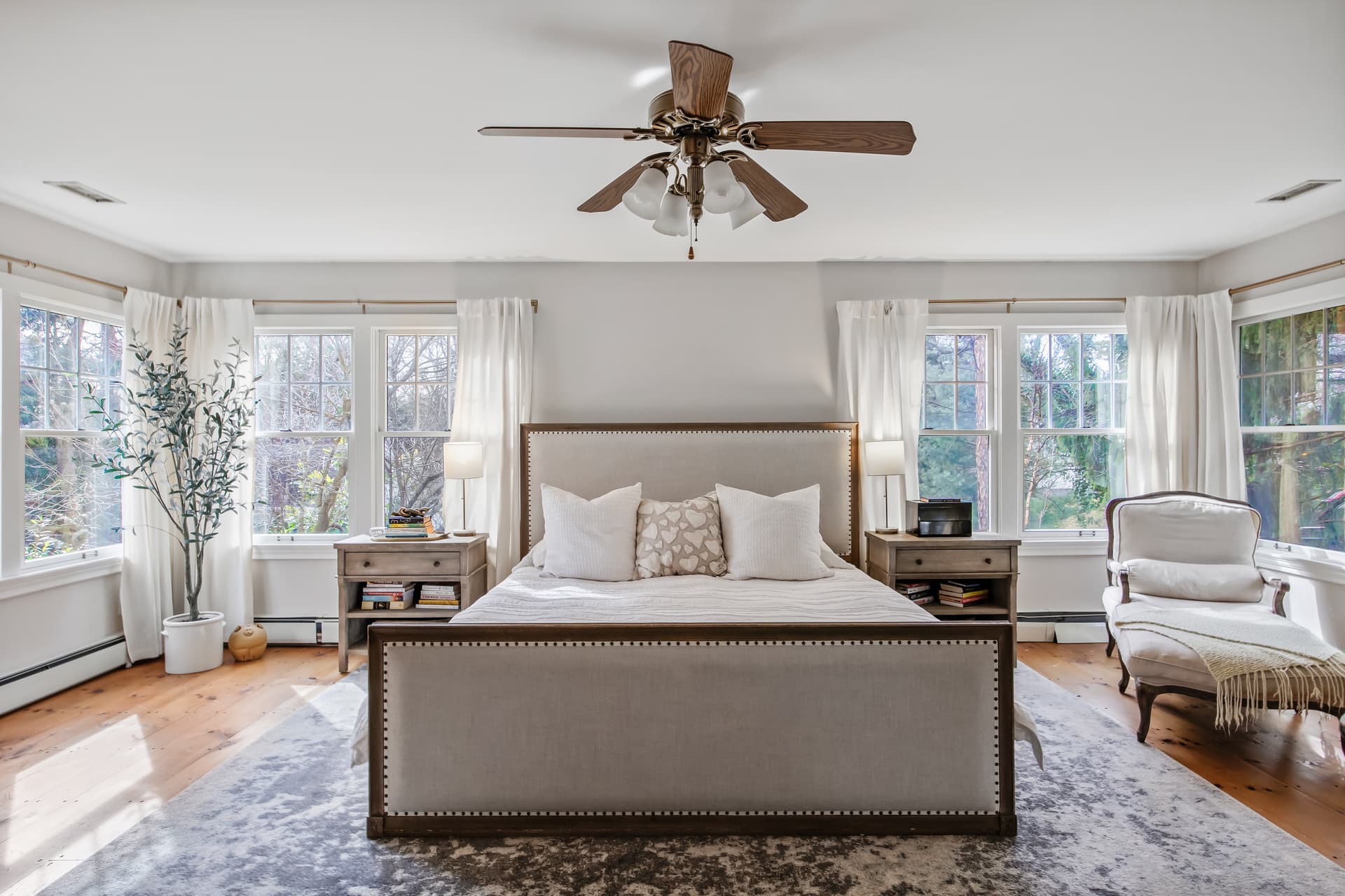 Primary bedroom with a wall of windows in a Moorestown home