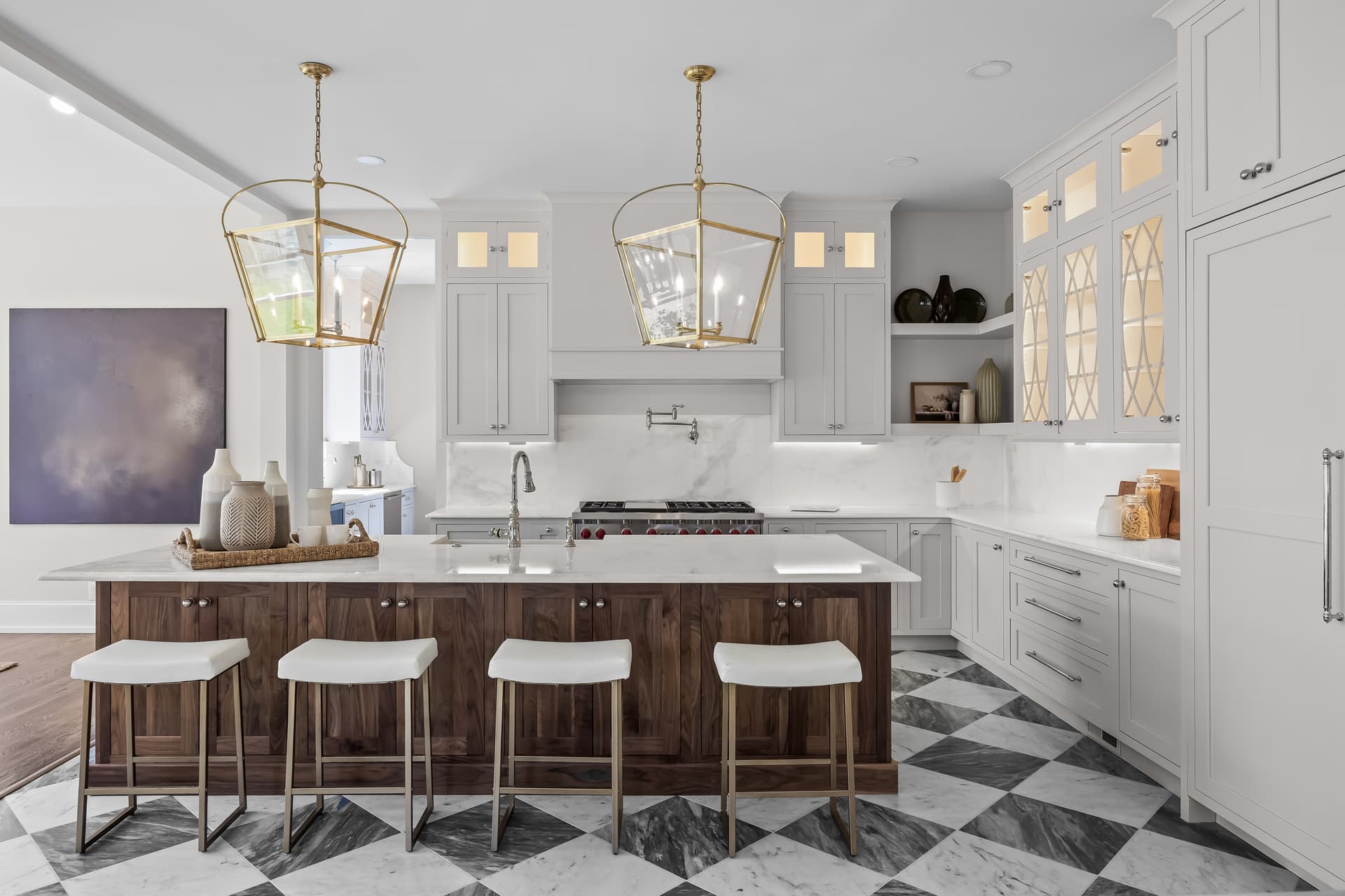 White chef's kitchen with a checkerboard floor and center island in a Moorestown home