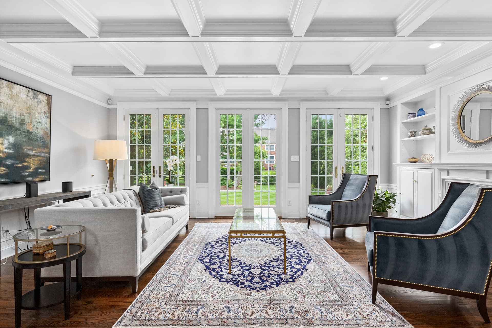 Living room with a coffered ceiling and French doors in a Moorestown home