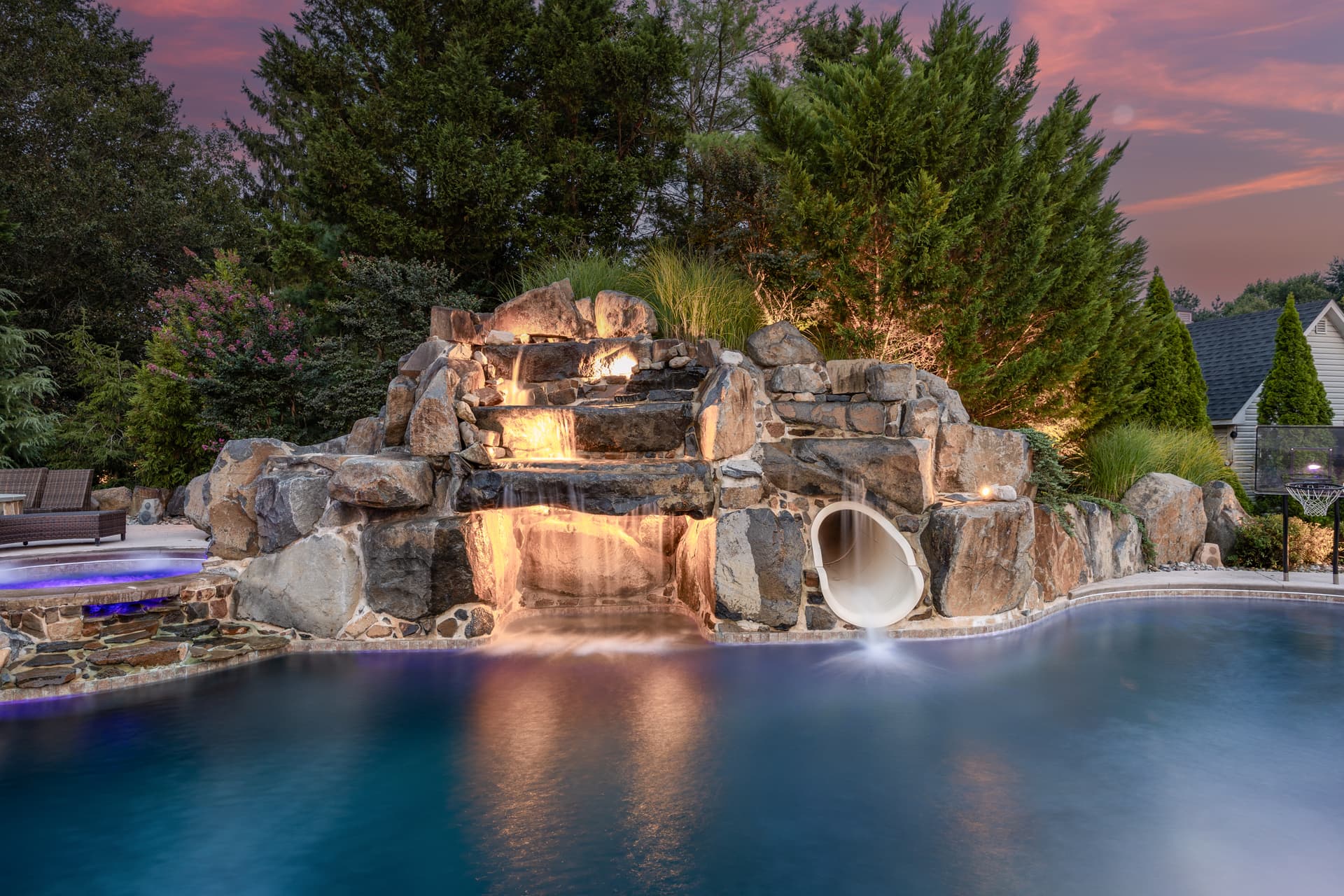 Twilight photography of a rock grotto waterfall and slide at dusk, South Jersey