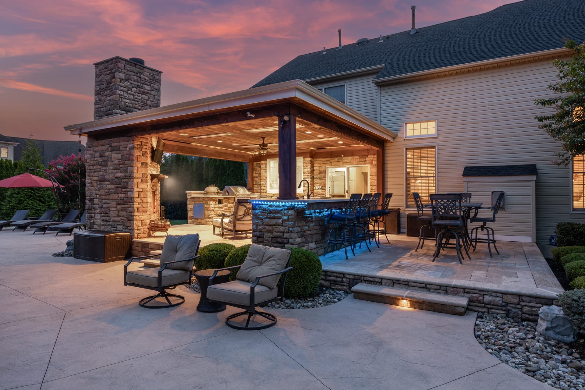 Twilight photography of an outdoor kitchen and lit bar at dusk, South Jersey